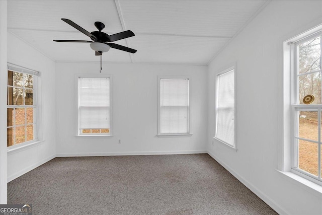 spare room featuring carpet flooring, baseboards, and ceiling fan