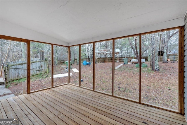 unfurnished sunroom with vaulted ceiling