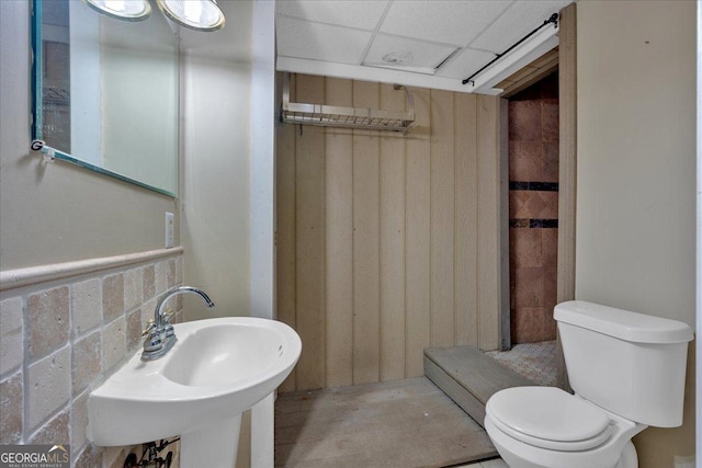 bathroom with a sink, a paneled ceiling, and toilet