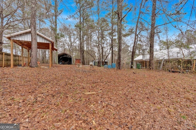 view of yard with a carport and an outbuilding