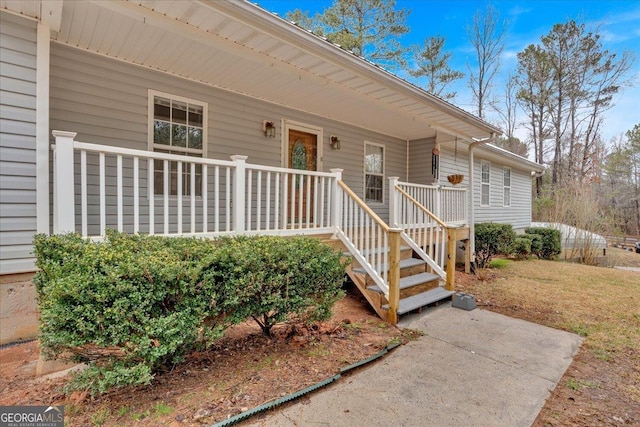 view of exterior entry with a porch