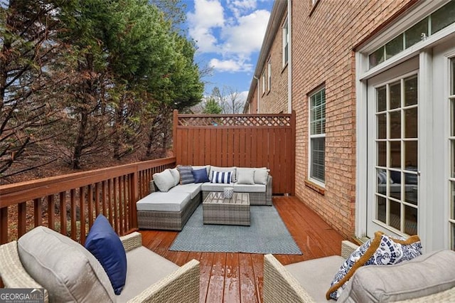 wooden terrace featuring an outdoor living space