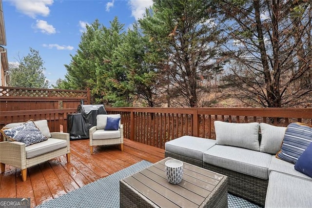 wooden deck featuring an outdoor living space and a grill