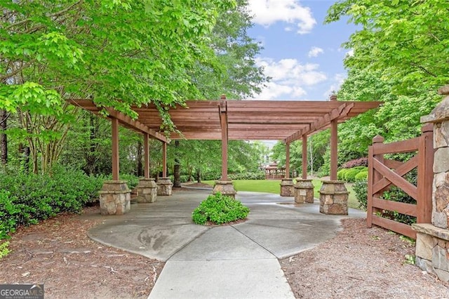 view of property's community featuring a pergola and a patio