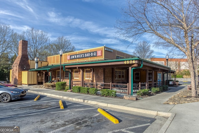 view of building exterior with uncovered parking