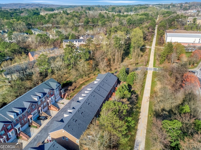 birds eye view of property featuring a forest view