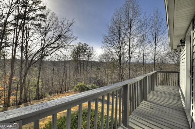 balcony featuring a wooded view