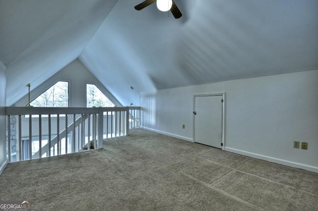 additional living space with baseboards, carpet, a ceiling fan, and vaulted ceiling