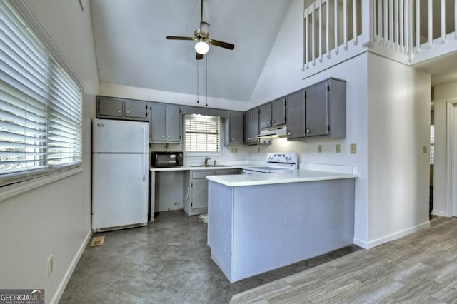 kitchen featuring white appliances, a peninsula, a sink, gray cabinetry, and under cabinet range hood