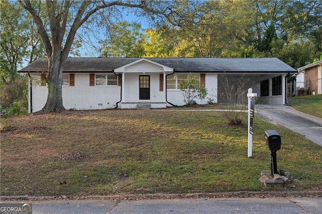 single story home featuring brick siding, a front lawn, a carport, crawl space, and driveway