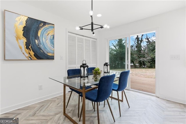 dining space with baseboards and a chandelier