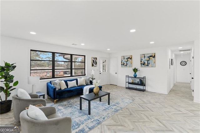 living area featuring recessed lighting and baseboards