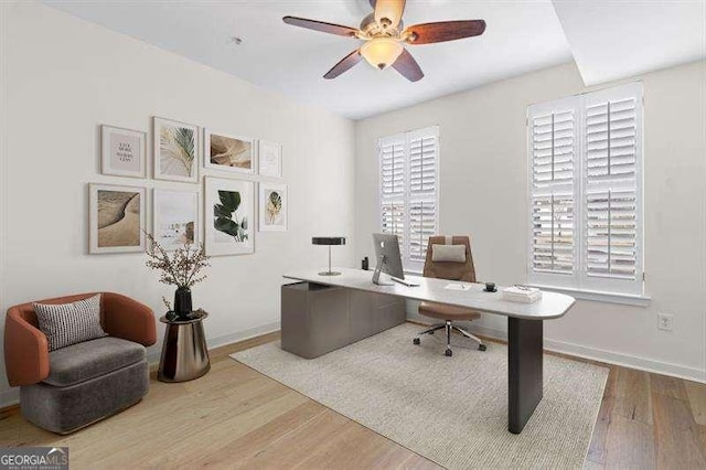 office space with wood finished floors, baseboards, and ceiling fan