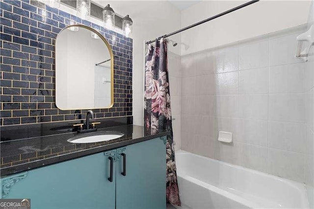 bathroom with tasteful backsplash, vanity, and shower / bath combination with curtain