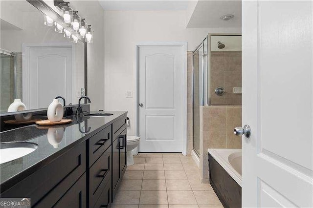 bathroom featuring tile patterned flooring, a shower stall, a garden tub, and a sink