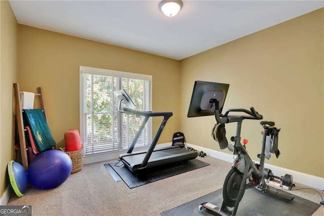 exercise area with baseboards and carpet