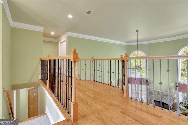 hall with recessed lighting, visible vents, ornamental molding, and wood finished floors