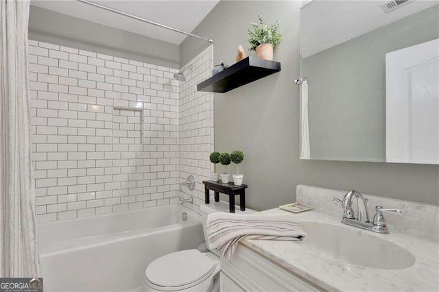 full bathroom with vanity, shower / tub combo, toilet, and visible vents