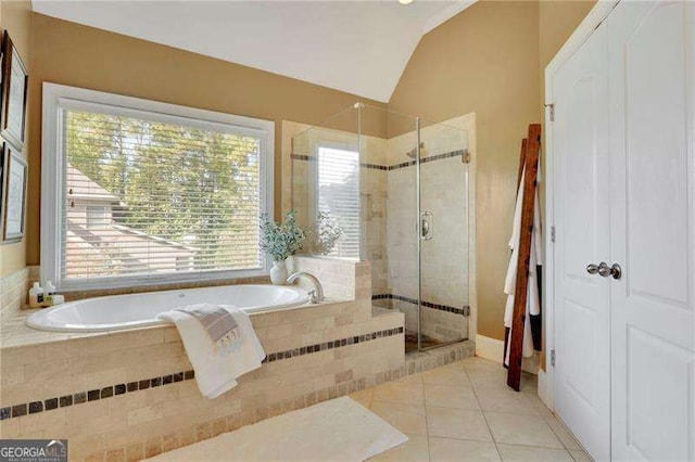 full bath with tile patterned floors, a stall shower, a bath, and vaulted ceiling