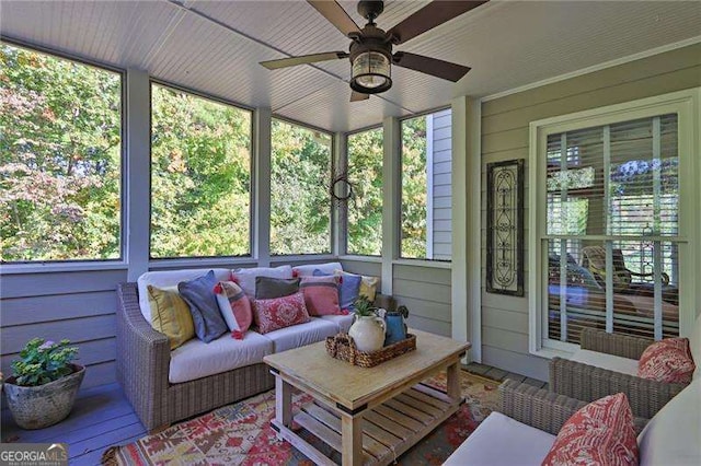 sunroom featuring a ceiling fan