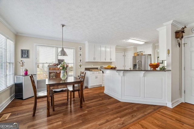 kitchen featuring dark wood finished floors, white cabinetry, and stainless steel refrigerator with ice dispenser