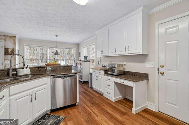 kitchen with light wood finished floors, ornamental molding, a sink, white cabinets, and dishwasher