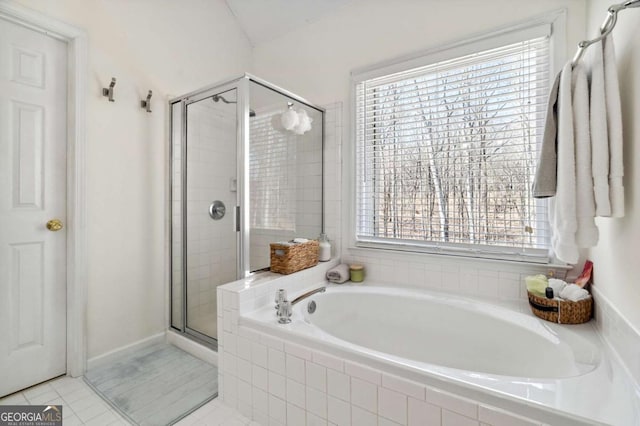 bathroom featuring tile patterned floors, a bath, and a shower stall