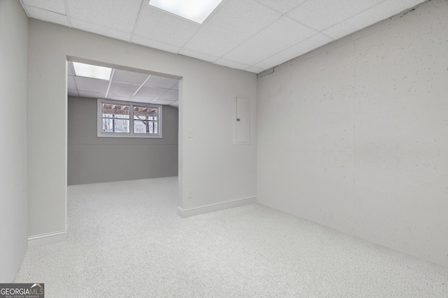 sitting room featuring electric panel, carpet, baseboards, and a drop ceiling