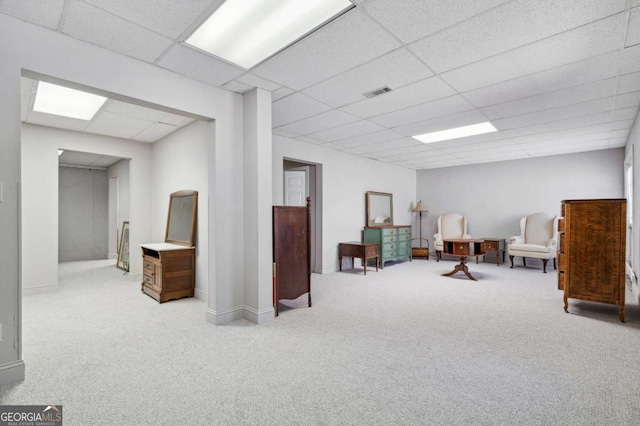 sitting room with visible vents, baseboards, a paneled ceiling, and carpet