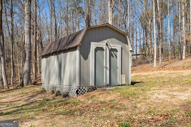 view of shed featuring fence