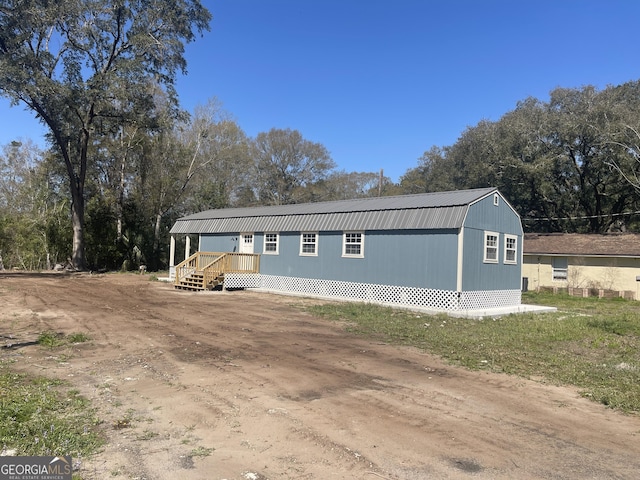 exterior space with metal roof and a gambrel roof