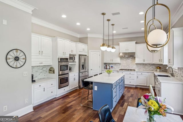 kitchen with a center island, white cabinetry, stainless steel appliances, and a sink