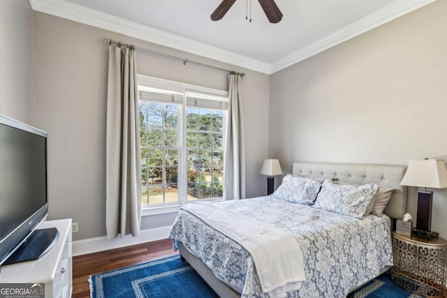 bedroom with baseboards, wood finished floors, a ceiling fan, and ornamental molding