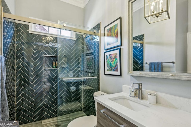 full bathroom featuring vanity, crown molding, toilet, and a shower stall