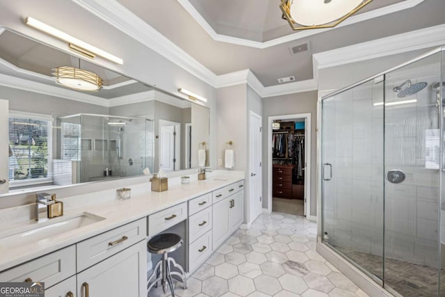 full bath featuring tile patterned floors, visible vents, a stall shower, a sink, and crown molding