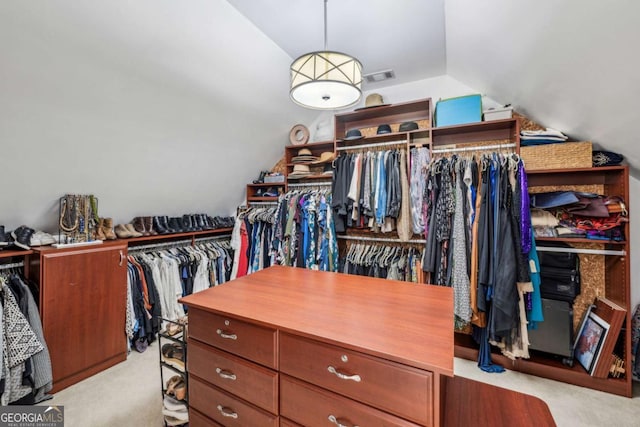 spacious closet featuring lofted ceiling, carpet, and visible vents