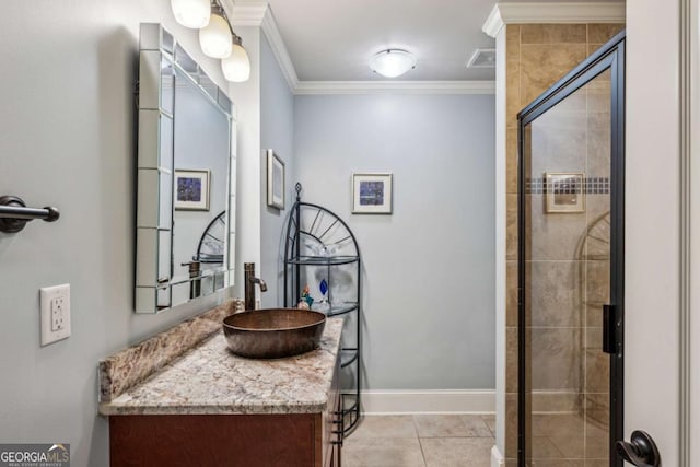 bathroom with baseboards, crown molding, tile patterned flooring, tiled shower, and vanity