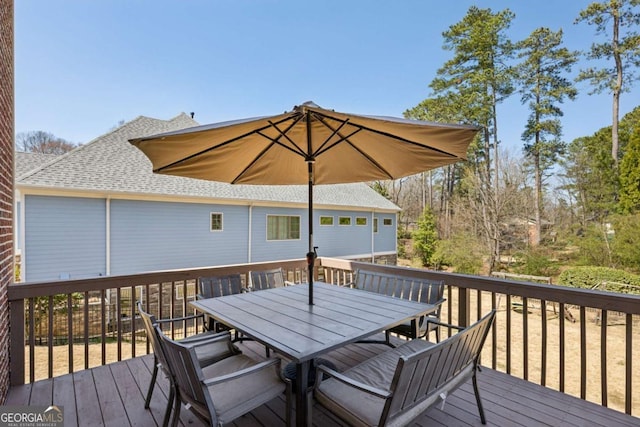 wooden terrace featuring outdoor dining area