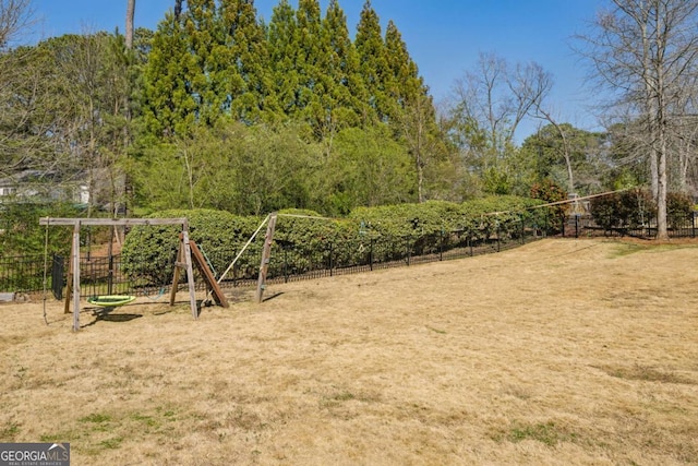 view of yard featuring a playground and fence