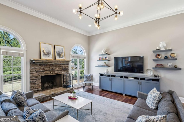 living room with crown molding, baseboards, a chandelier, a fireplace, and dark wood-style flooring