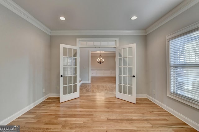 empty room featuring visible vents, light wood-style flooring, baseboards, and a healthy amount of sunlight