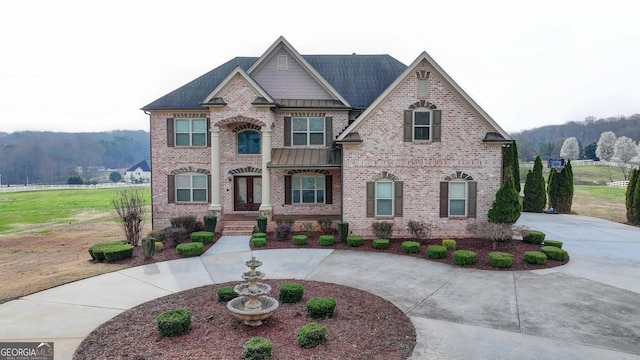 craftsman-style home featuring brick siding, curved driveway, french doors, and roof with shingles