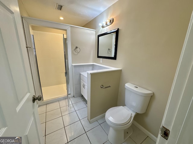 bathroom with visible vents, a shower stall, toilet, tile patterned floors, and vanity