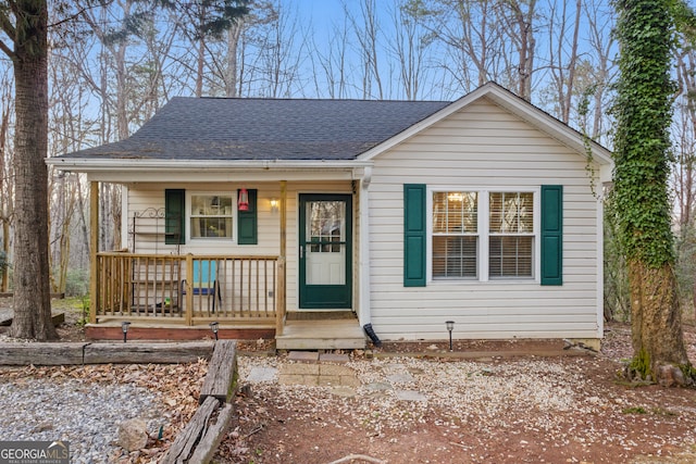 bungalow-style home with a porch and a shingled roof