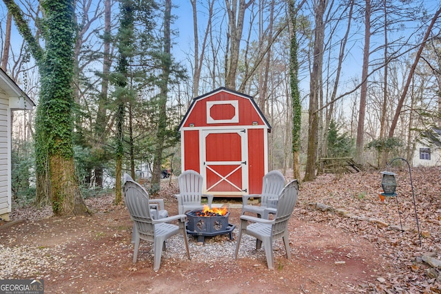 view of shed with an outdoor fire pit