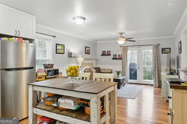 dining area with a wealth of natural light, french doors, and crown molding