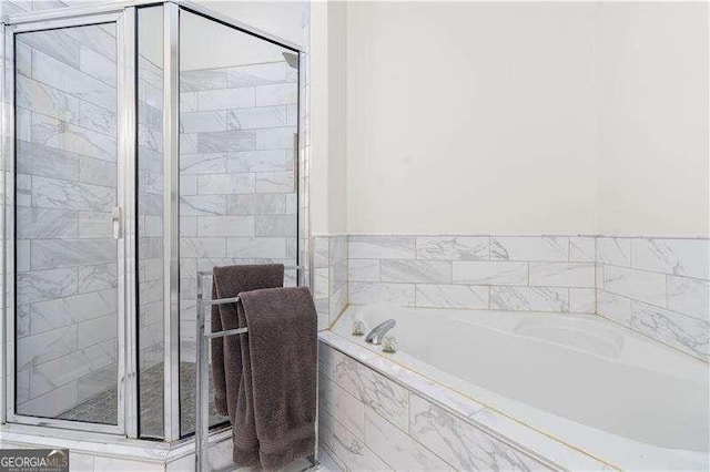 full bath with a garden tub and a stall shower