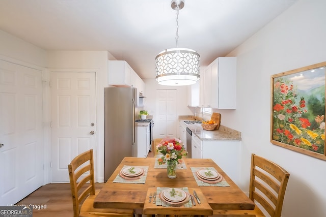 dining space featuring light wood-type flooring