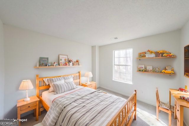 carpeted bedroom with baseboards and visible vents