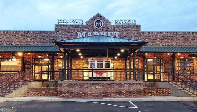 view of building exterior with uncovered parking